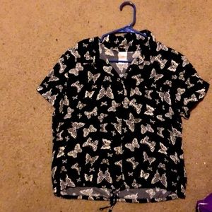 Black button up shirt with white butterflies all over.